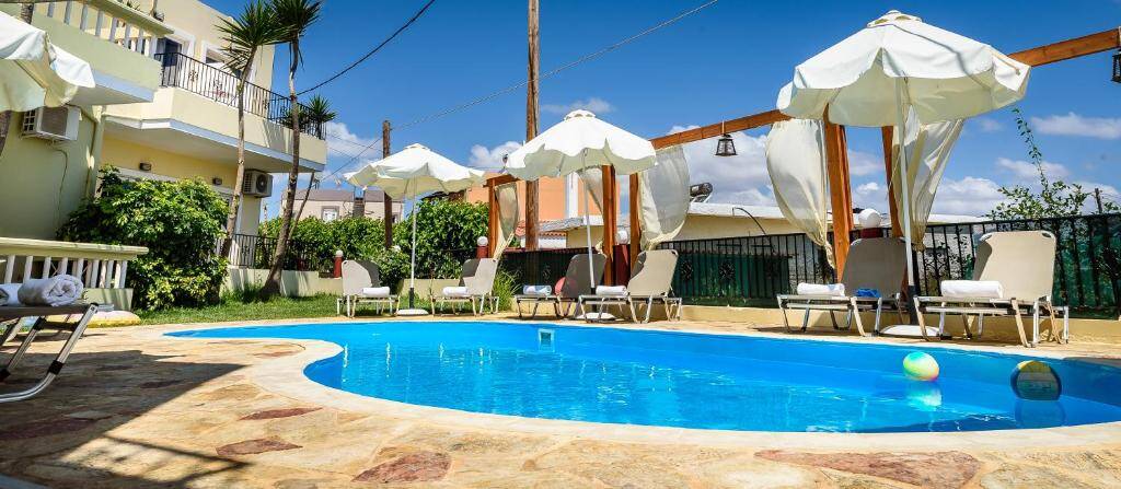 Outdoor swimming pool with loungers and umbrellas